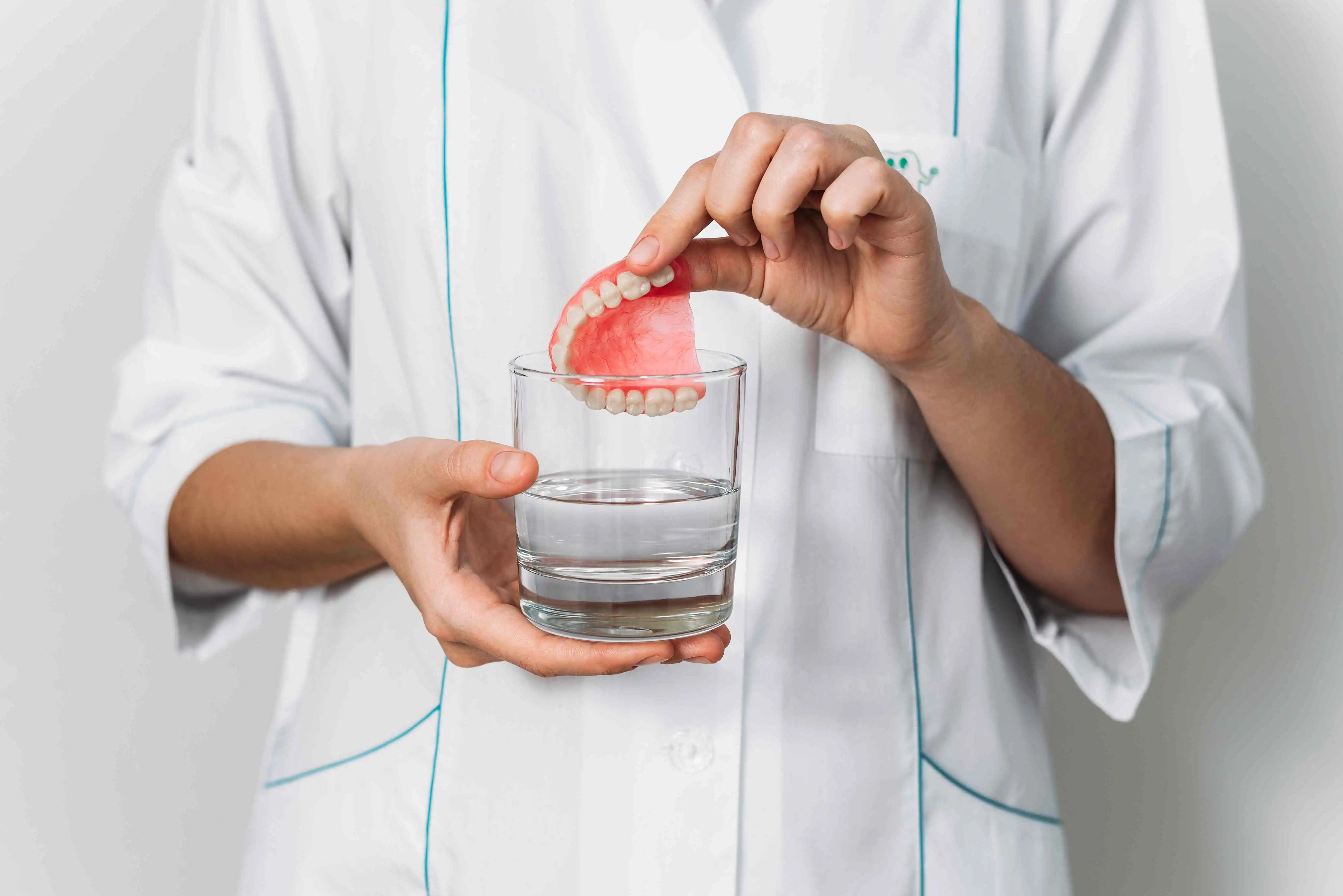 Rinse your dentures under water after eating.