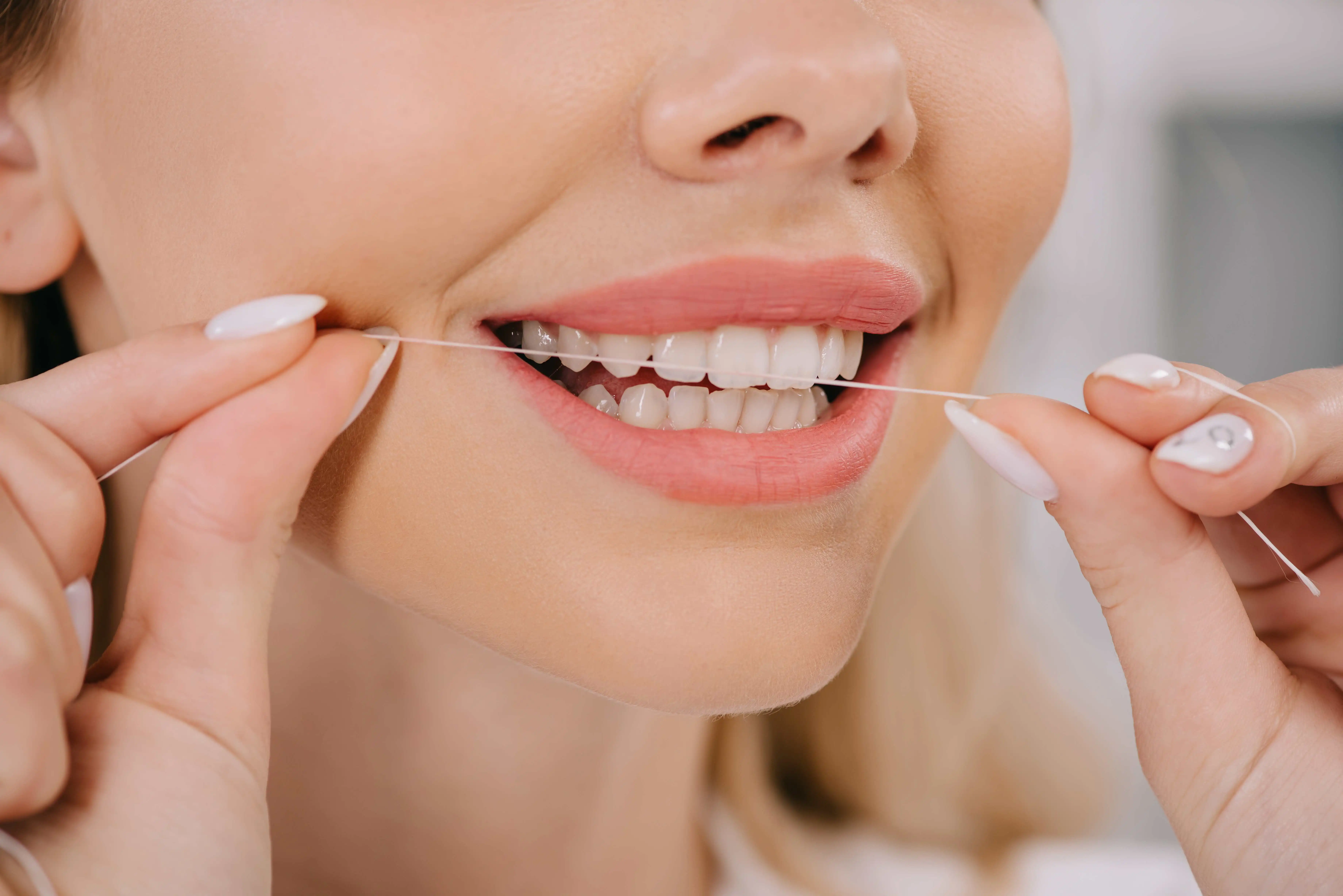 woman flossing teeth
